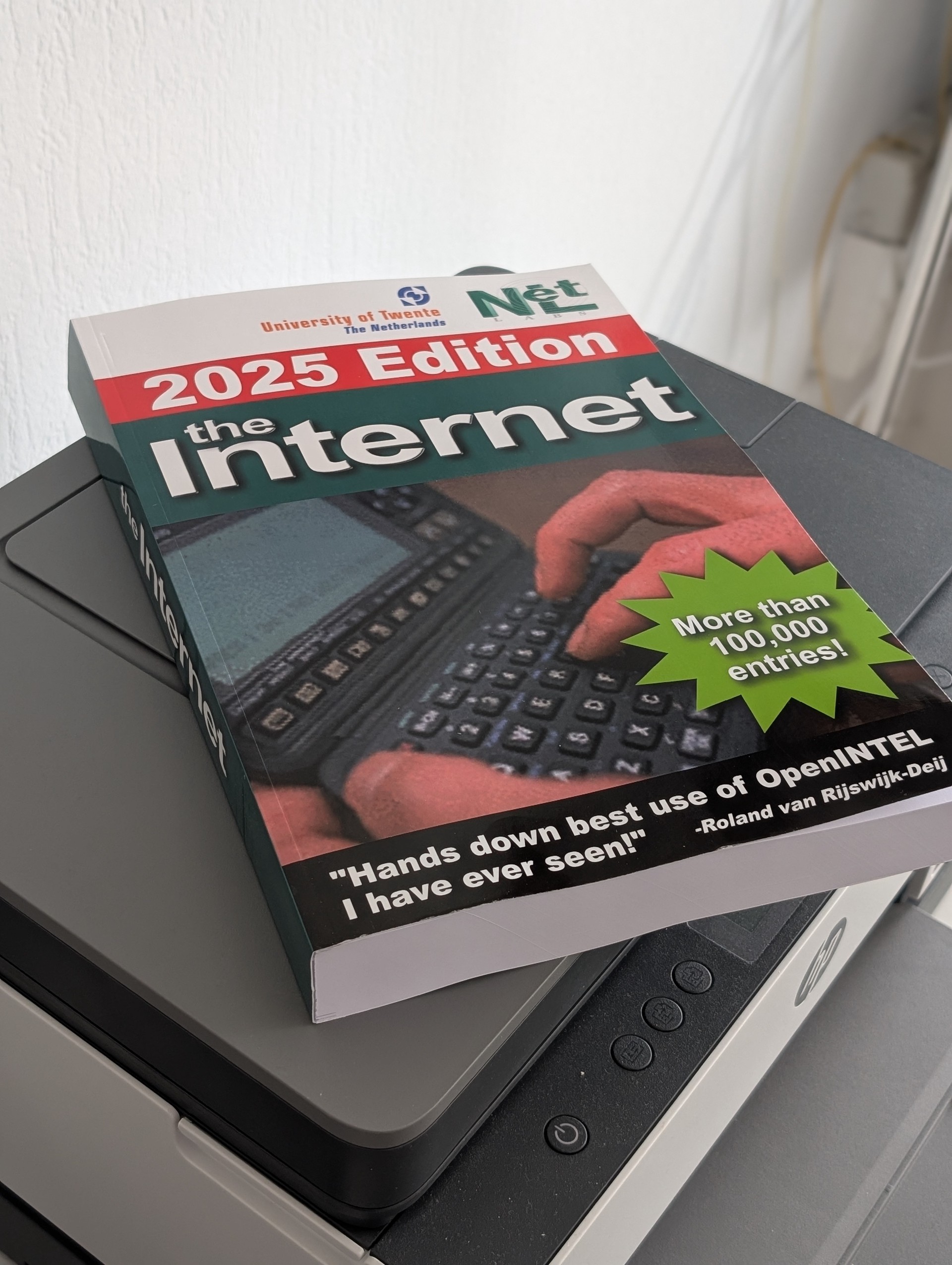 A picture of the phone book of the internet laying on a printer